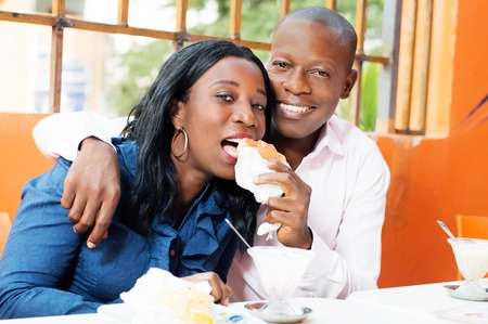 happy young man put the bread in the mouth de son wife.の写真素材