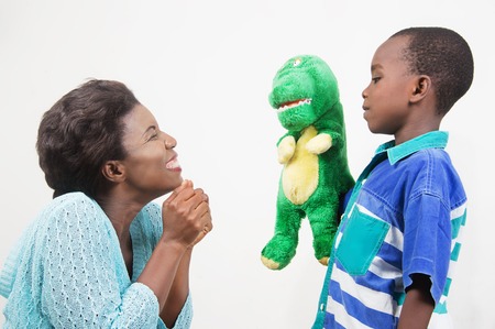 Child playing with His Mother holding a toy in hand.の写真素材