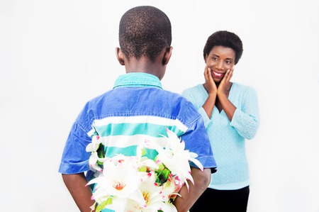 This child hidden in a flower His back he wants to offer her mother for mother? ? ? s day.の写真素材