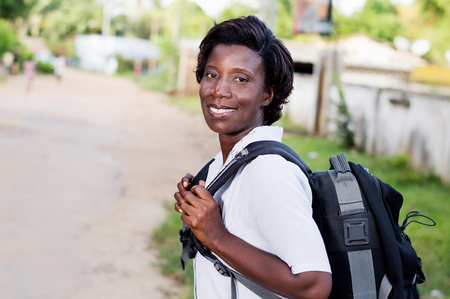 Travel, tourism - smiling young woman with backpack ready to hit the road.の写真素材