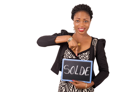 Portrait of a young business woman smiling holding a slate on which it is written reduction.の写真素材