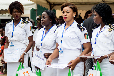 Abidjan, Ivory Coast - August 3, 2017: Epaulette and graduation ceremony for students leaving the Maritime Academy. group of marine women dressed in white and holding diplomasのeditorial素材