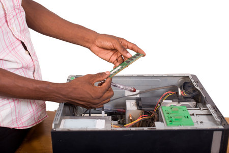 closeup of technician hands repairing a computer while holding a memory pad isolated on white...