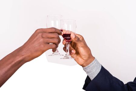 businessmen clinking wine glasses on white backgroundの写真素材