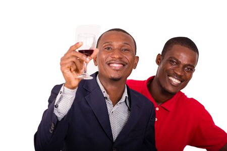 Young happy people toasting with wine for a party in studio on a white backgroundの写真素材
