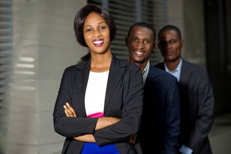 Young business people in a row, smiling for a business meeting.の写真素材