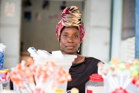 Saleswoman behind handy stand.の写真素材