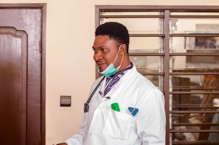a young doctor standing in his office and looking at the camera.の写真素材