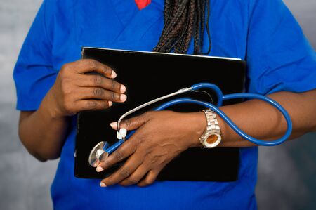 Female doctor's hands holding stethoscope and notebook. Medical help or insurance concept. Doctor receiving conceptの写真素材