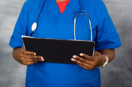 close up of woman hands holding a notebook on bright background