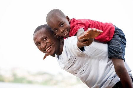 Portrait of father with his son having fun in the park in summer. Happy family fun boy playing with dad summer nature outdoorsの写真素材