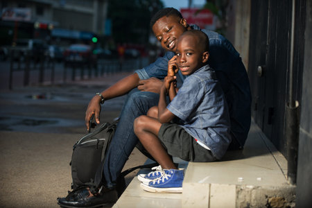Cute little boy and his father are waiting for bus on the platform of the train station. Travel,...