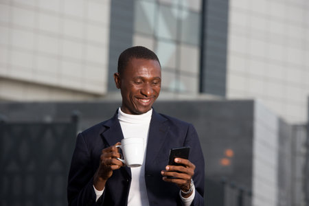 young businessman drinking coffee in town and using a smart phone. Business Concept, Lifestyle and...