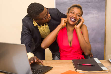 Young and beautiful business people working together on a desktop computer in a modern office Woman sitting speaks on the phone.の写真素材