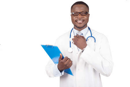 Man in a white coat, doctor or scientist writes notes on paper and puts on his tie.の写真素材