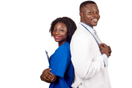 standing medical team in gown with clipboard looking at camera smiling.の写真素材