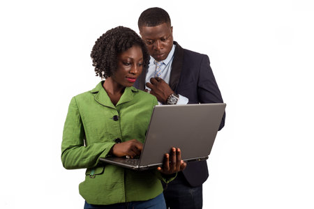 business people standing on white background looking at laptop smiling.