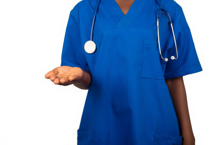 Female nurse or professional doctor standing in blue blouse, wearing a stethoscope on the neck and having a hand gesture, health care conceptの写真素材
