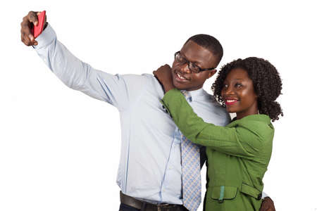 friends and office colleagues in formal outfit is happy and taking self portrait with smart phone isolated in studioの写真素材