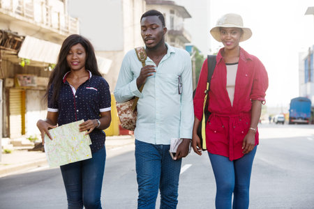 young tourists walk in the city smiling.