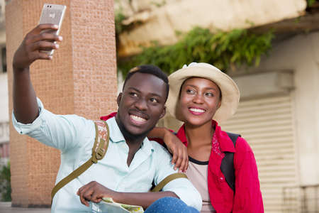 couple of young tourists with mobile phone, happy.の写真素材