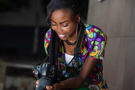 young woman sitting in a hurry to look at camera smiling.