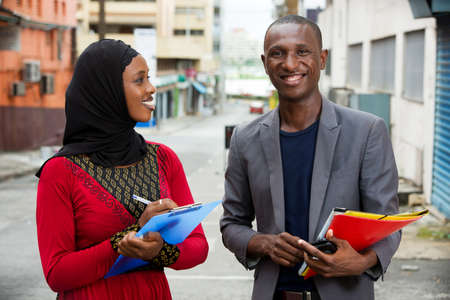 young business people standing in the street working with a smile.の写真素材