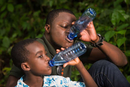 Close-up of a family in the countryside with water bottle.の写真素材