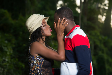 young happy couple standing give each other kisses.