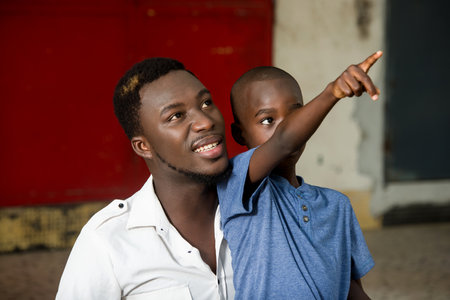 happy father with his son in the park. Child pointing finger something. happy family conceptの写真素材
