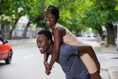 Smiling beautiful young couple in love, on the street, dating and having fun together.の写真素材