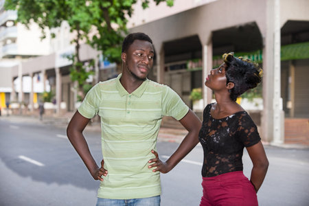 smiling couple with the city in the background. Handsome romantic man and beautiful woman enjoying the evening walk.の写真素材