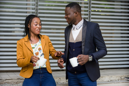 Sharing experience with a colleague, man and businesswoman having coffee outdoors.Man with beard and sexy woman at business lunch.の写真素材
