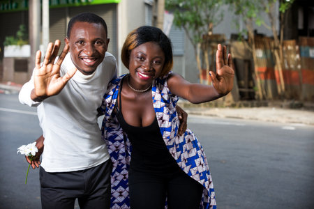 Two friends embraced happy together and greeted on the street of a big city. Concept wedding or holidays with twoの写真素材