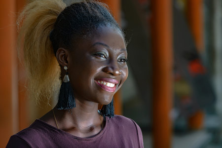 young girl standing in purple t-shirt looking at camera smiling.