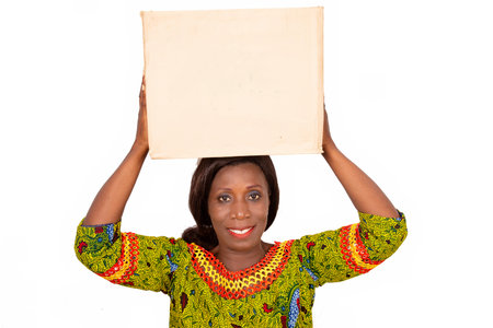 beautiful African adult woman wearing a green loincloth with long hair, is standing holding a...
