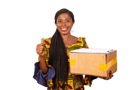 beautiful african woman in traditional clothes standing on white background looking at camera...