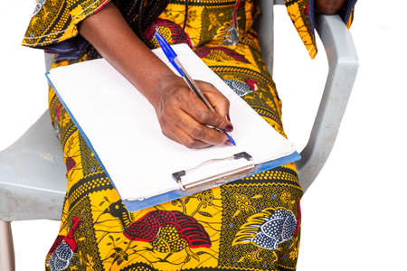 businesswoman hand sitting writing on report paperの写真素材