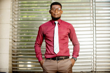 Photo of a handsome young handsome businessman outdoors in the street near the business center...