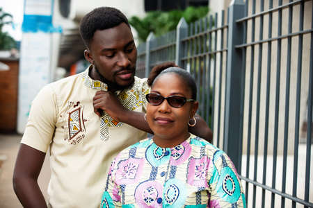 happy beautiful young couple talking on the street posing together smilingの写真素材