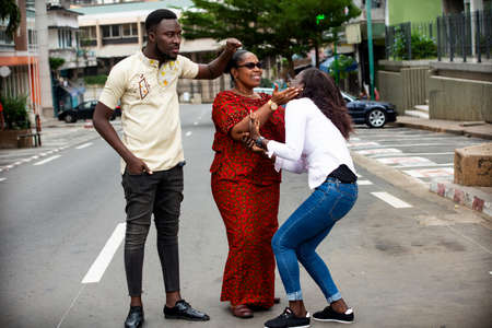 beautiful happy family standing and walking outdoors in the street talking while being smilingの写真素材