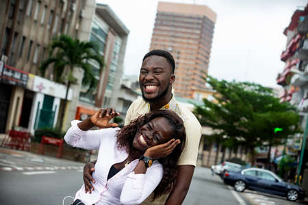 young couple in love standing in the street laughing.の写真素材