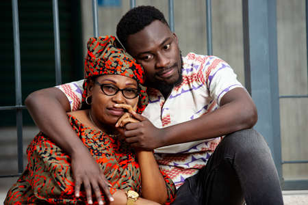 a beautiful couple in traditional dress sitting on stairs crying.の写真素材