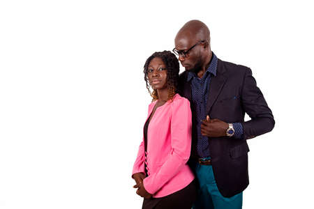 beautiful young couple in love african, standing in the arms of her husband while smilingの写真素材