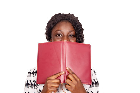 beautiful young isolated woman covering a notebook, book, diary, on the face and looking at camera...