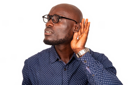 handsome businessman standing in glasses on white background making sign of listening