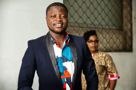 business people standing indoors posing indoors and looking at camera smiling