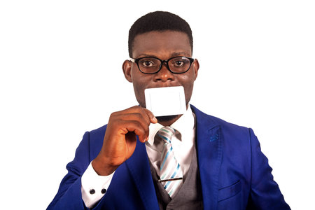 handsome young businessman wearing blue jacket with glasses holding card playing isolated on white...