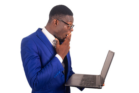 a handsome businessman in jacket standing isolated on a white background surprised while looking at...