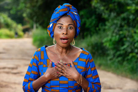 adult business woman positively surprised and opening mouth with hands on chest.の写真素材